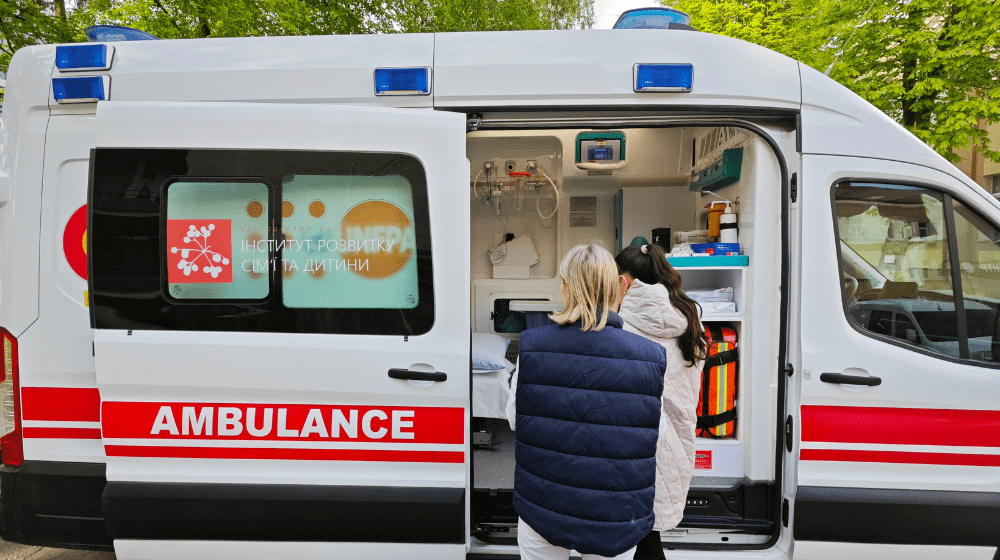 UNFPA-supported mobile gynaecological team members in front of a mobile gynaecological clinic 