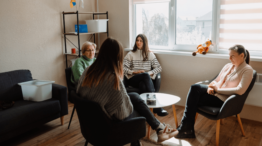 Four women talk together 