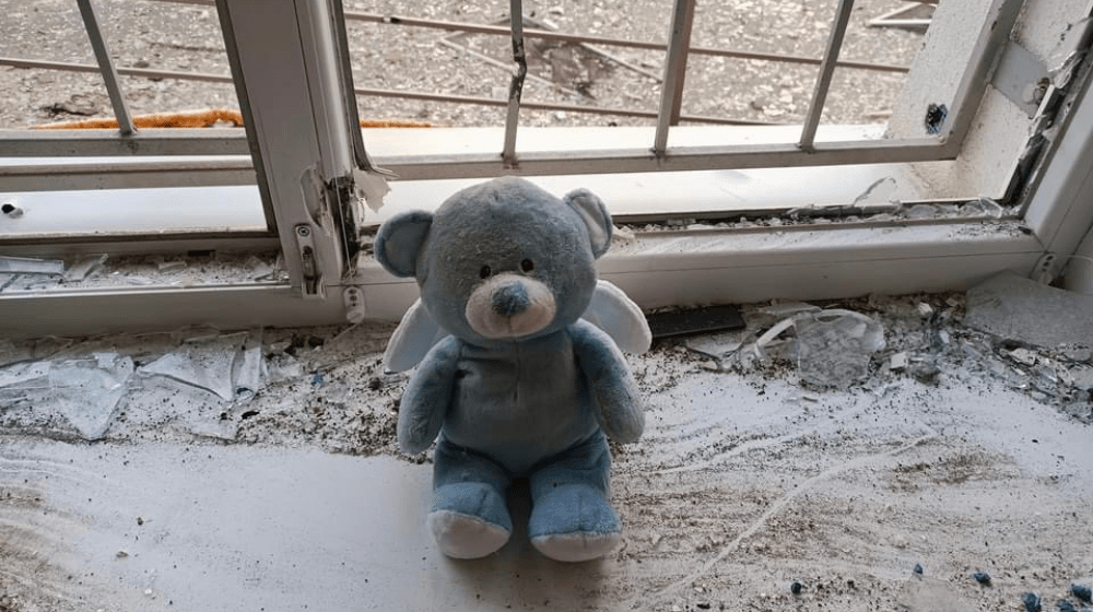 Children's toy on a broken window